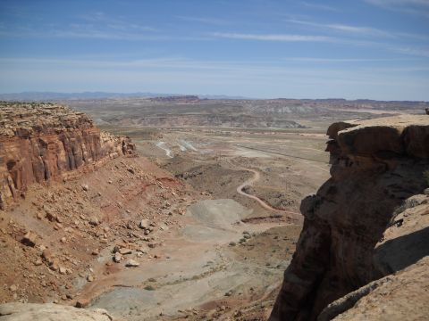 1986 Ford Bronco II - Vast desert scenery with dramatic rock formations and a road disappearing into the distance.