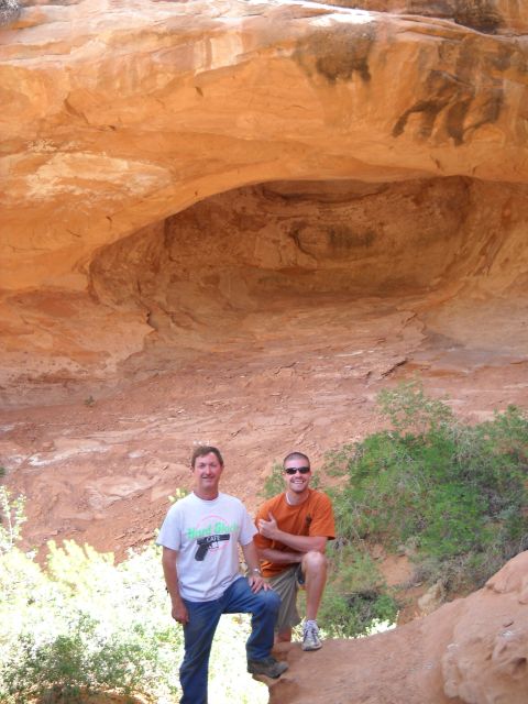 1986 Ford Bronco II - Two men pose for a photo in a desert landscape with a large rock overhang above them.