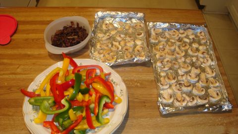 1996 Ford Bronco - Ingredients for a meal, including sliced bell peppers, mushrooms, and onions, are arranged on a wooden table.