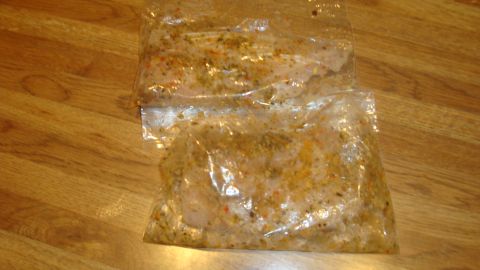 1996 Ford Bronco - Food items in plastic bags are placed on a wooden table. Supermotors.net logo is visible.