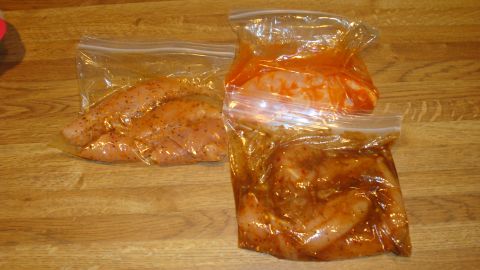 1996 Ford Bronco - Chicken breasts marinating in plastic bags on a wooden surface.