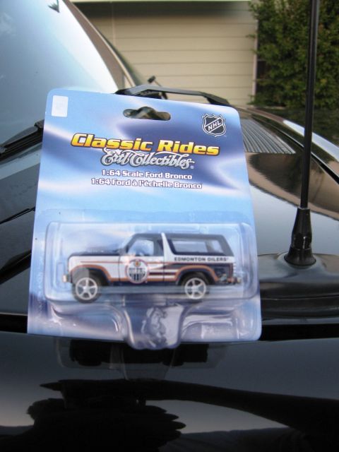 1986 Ford Bronco - A diecast 1:64 scale Ford Bronco toy is shown in its original packaging, Edmonton Oilers graphics.