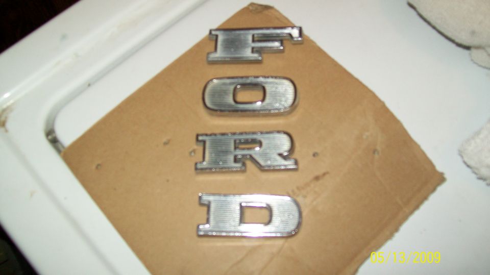 Chrome FORD letters on cardboard