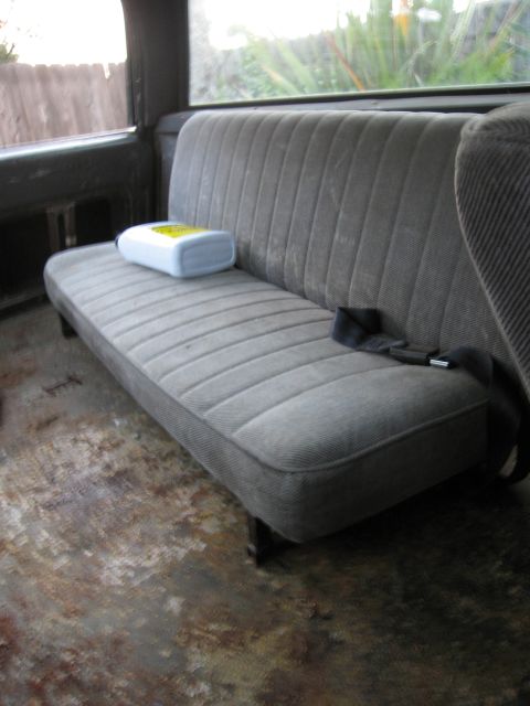 1986 Ford Bronco - Interior view of a vehicle's bench seat, with a bottle placed on the cushion.