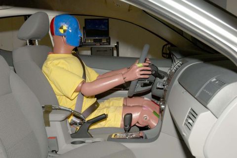 1971 Ford Ranchero - A crash test dummy is positioned in the driver's seat of a vehicle, ready for a safety test.