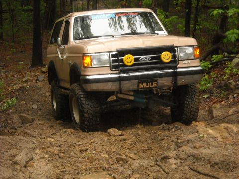 1979 Ford F-150 - This Ford Bronco is navigating a challenging muddy off-road course.