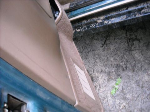 1979 Ford F-150 - Close-up of a vehicle's interior door panel and carpet, with a textured insert visible.