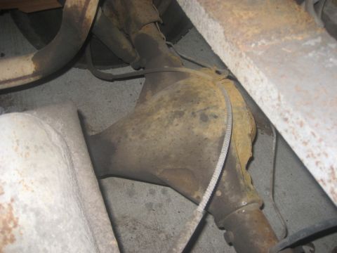1983 Ford F-250 - Underside view of a vehicle's rusty differential and exhaust system components.