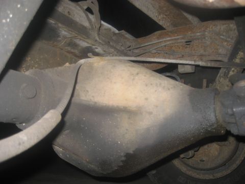 1983 Ford F-250 - Close-up of the rear axle assembly, showing brake lines and suspension components.
