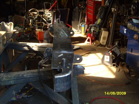 1989 Ford Bronco - A close-up view of a metal bumper part, likely for a truck or SUV, in a workshop setting.