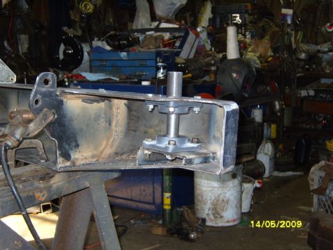 1989 Ford Bronco - A metal bracket with a bearing assembly is shown in a workshop setting.