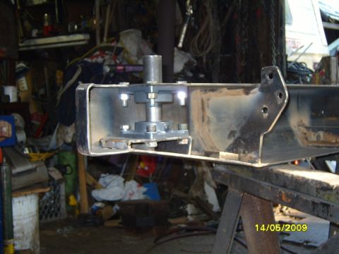 1989 Ford Bronco - A close-up view of a rear bumper bracket with a metal post assembly attached, likely for a trailer hitch or similar component.