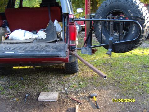 1989 Ford Bronco - Rear view of a 1989 Ford Bronco with its tailgate open and a spare tire carrier attached.