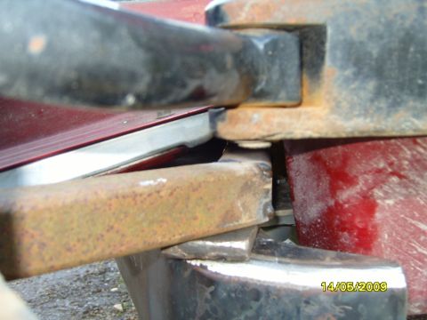 1989 Ford Bronco - Close-up of a rusted bracket on the rear of a vehicle, with visible text overlay.