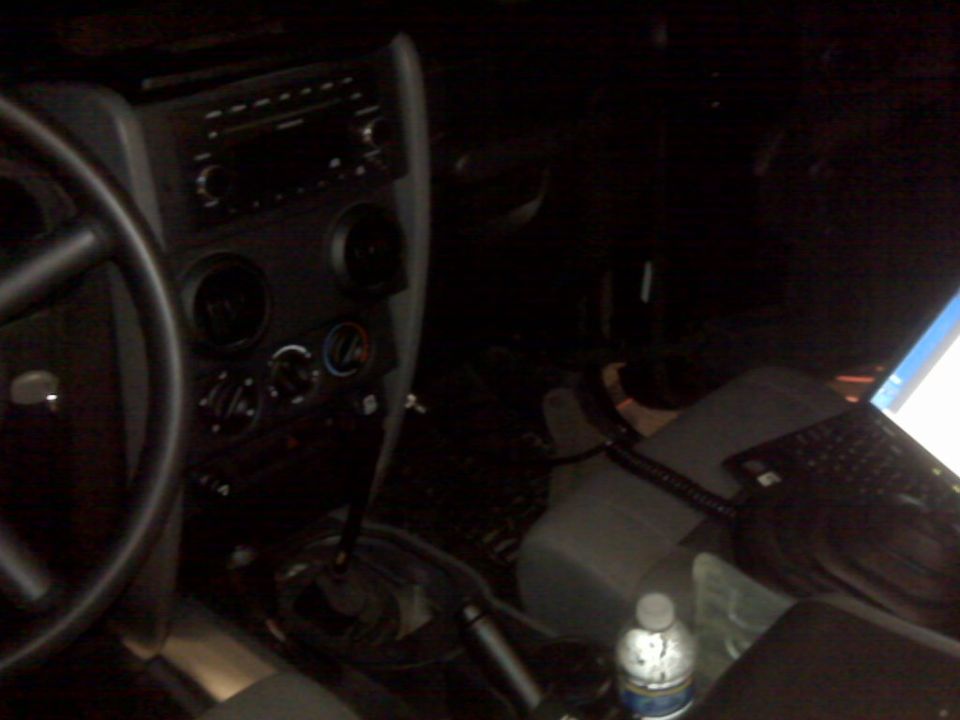 Jeep Wrangler interior with steering wheel, dashboard, and center console visible
