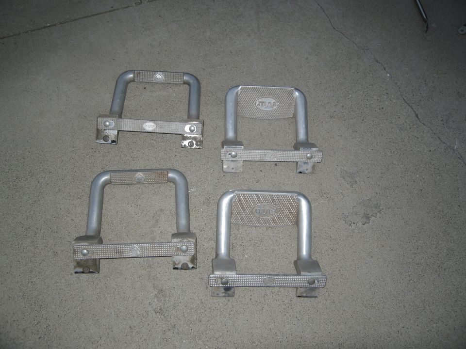 Four metal step bars with textured grip surfaces and visible mounting brackets