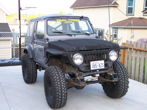 1988 Suzuki Samurai - This modified Suzuki Samurai is equipped for off-road adventures with its lifted suspension and aggressive tires.