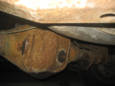 1983 Ford F-250 - Underside view of a heavily rusted rear differential and frame components.