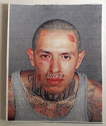 1988 Ford Bronco - This is a mugshot of a man with visible tattoos on his face and neck.