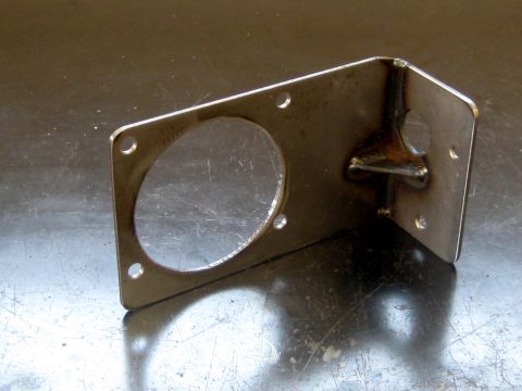 1996 Ford Bronco - This is a custom metal bracket, likely for automotive use, with a large circular cutout.