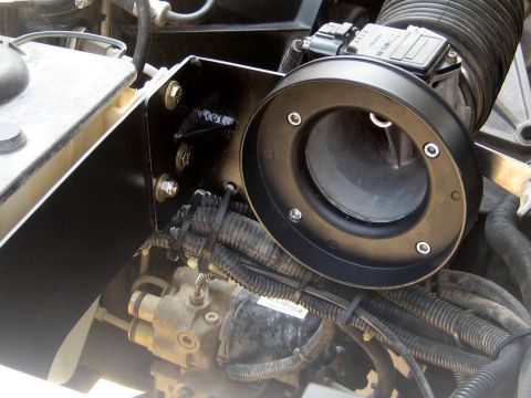 1996 Ford Bronco - This is a close-up view of an engine's air intake system, showing the air filter housing and mass airflow sensor.