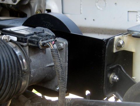 1996 Ford Bronco - Close-up of an engine air intake assembly, including a mass airflow sensor and a black heat shield.
