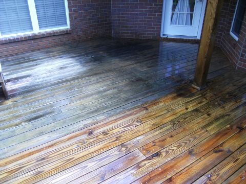 1992 Ford F-150 - The deck shows a clear difference between the cleaned and uncleaned sections, with water pooling on the surface.