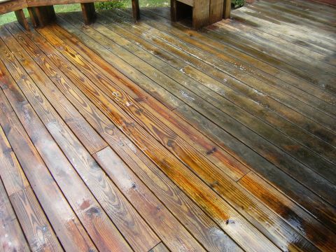 1992 Ford F-150 - A wooden deck shows a stark contrast between the cleaned and uncleaned sections, with water visible on the planks.