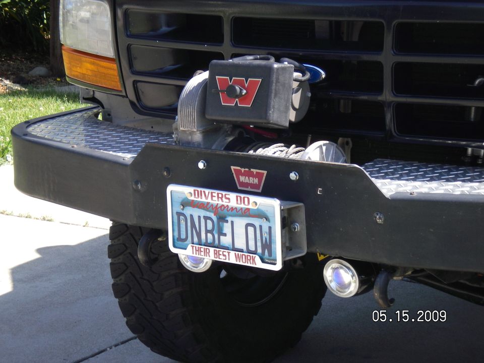 The 8274 is a high power, very fast line speed, winch with 150' of cable and fits perfectly into the area that was designed for it in the Warn bumper. Mounted the license plate with the maglight plastic clamps like Bossind from FSB did and it works like a charm. Push the plate till the clamps click onto the roller fairlead, pull to remove! That's why the extra bolts are drilled into the plate by the letter "D" & "W" to mount the clamps. I've got an older gentleman, on Craig'sList fabbing up a metal solenoid cover to replace the plastic one like he did for his 8274...