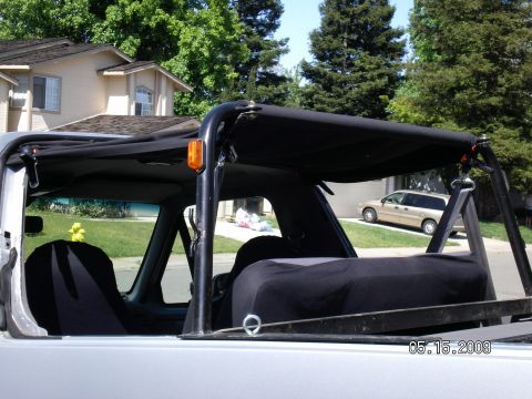 1996 Ford Bronco - The rear of the soft top is velcro'd and wrapped 360 deg around the show bar I just picked up. I used eye hole bolts to mount the front to…