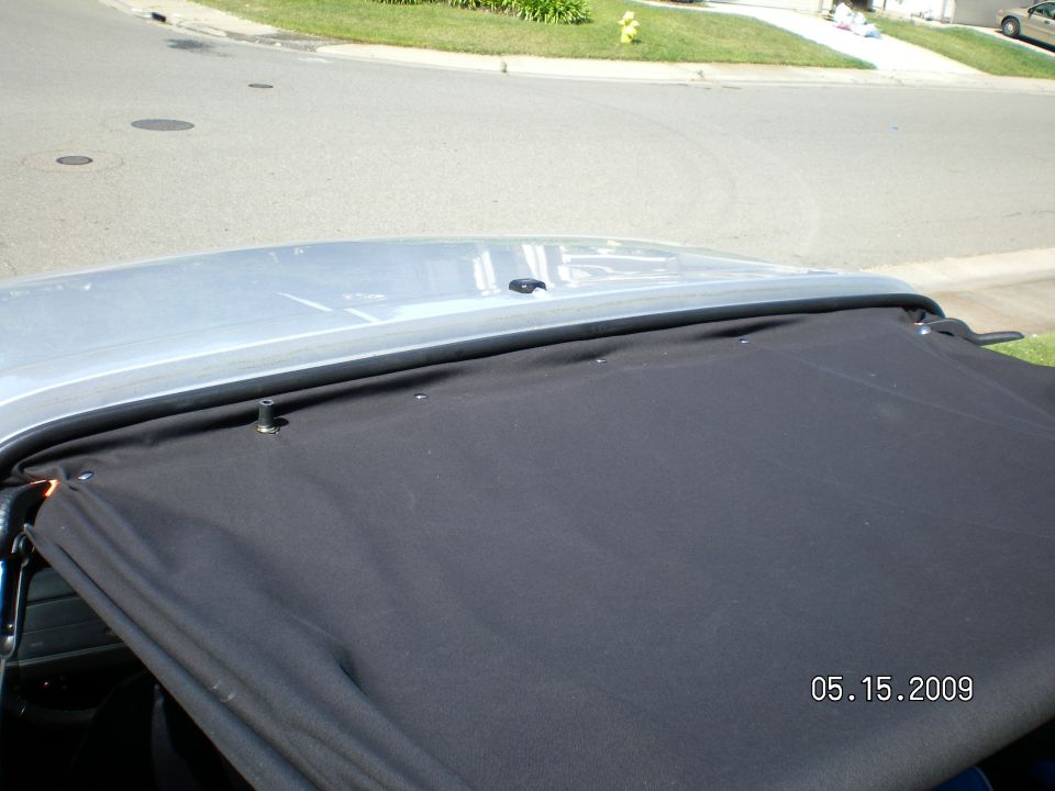 The soft top is loose since I just removed a few snaps to install & sew in a couple 3 foot lengths of 1/2" aluminum flat bar, I picked up today at Home depot,  to keep the sides from flapping. It's already stable at 65 mph but on surface roads, no freeway till it's all buttoned up. Sirus satelite antenna is mounted right into the roof and is accessed by removing the inside courtesy lamp.