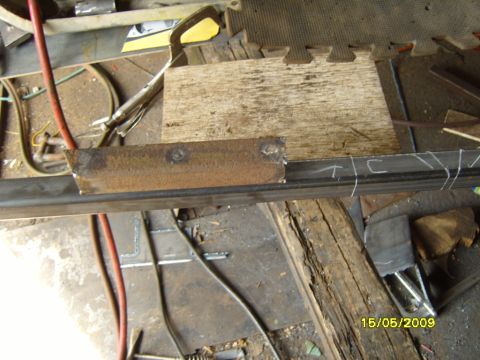 1989 Ford Bronco - Metal fabrication work in progress with chalk markings on a steel beam.