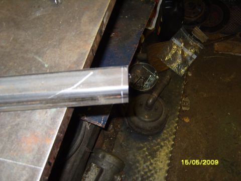 1989 Ford Bronco - A metal bar with scribe lines is shown on a workbench, with various tools and hardware in the background.