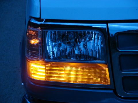 1995 Ford Bronco - The illuminated turn signal and headlight assembly on the front of a truck.