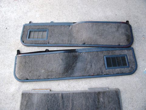 1986 Ford Bronco - Two gray carpeted interior door panels with air vents are displayed, along with a third partial panel below.