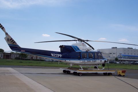 2001 Ford Crown Victoria - A U.S. Park Police helicopter is parked on a trailer on an airfield.