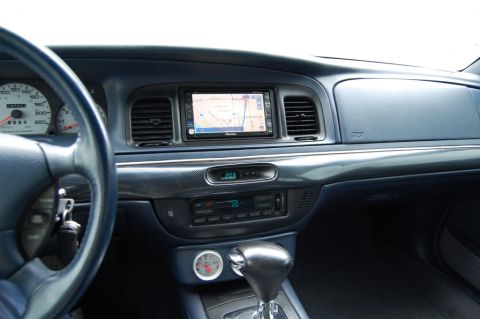1985 Mercury Grand Marquis - The interior of a car shows the dashboard with a navigation system and climate controls.