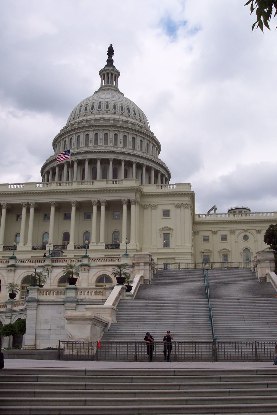 United States Capitol Building with wide stone steps and two guards