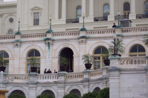 2001 Ford Crown Victoria - A view of the US Capitol Building's facade, showing architectural details and individuals on a balcony.