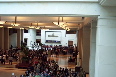 2001 Ford Crown Victoria - A crowded interior of a large public building, possibly a museum or government building, with many people gathered.