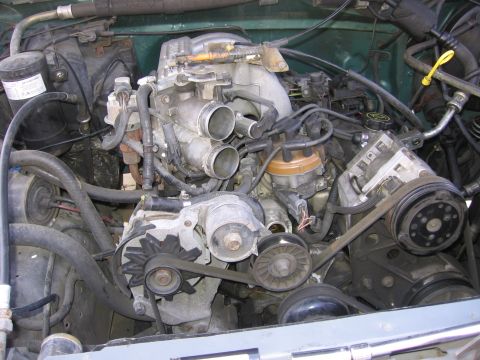 1990 Ford Bronco - Close-up view of a V8 engine, showing various components and wiring.