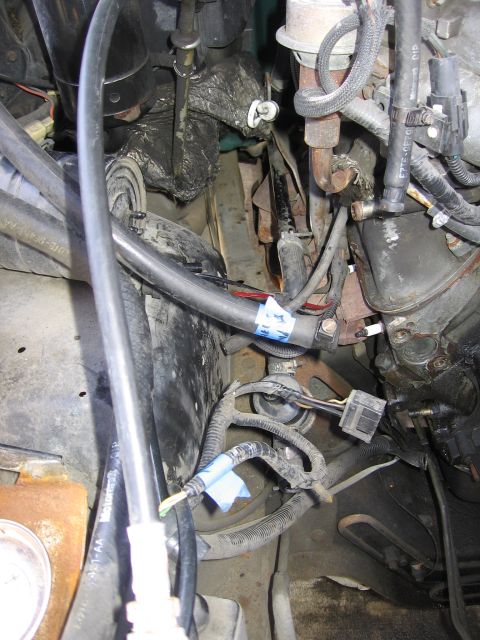 1990 Ford Bronco - Close-up view of an engine compartment, showing various hoses and wiring.