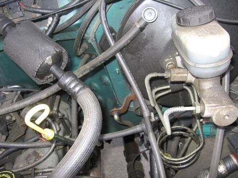 1990 Ford Bronco - Detail shot of engine bay components including the brake master cylinder and air intake system.