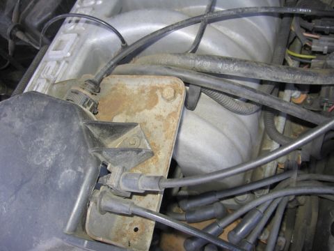 1990 Ford Bronco - Close-up view of engine components, including a distributor cap and spark plug wires.