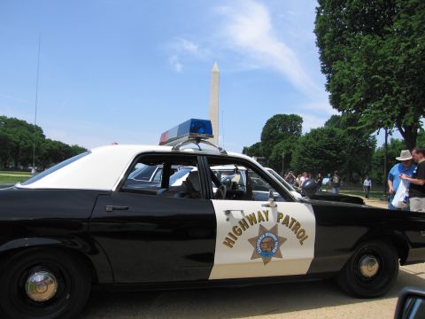 1991 Ford LTD Crown Victoria - black-and-white sedan with California Highway Patrol star and roof light bar parked in front of the Washington Monument.