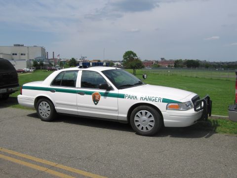 1991 Ford LTD Crown Victoria - white and green Park Ranger Ford Crown Victoria cruiser, marked with the National Park Service arrowhead emblem, sits on grass.
