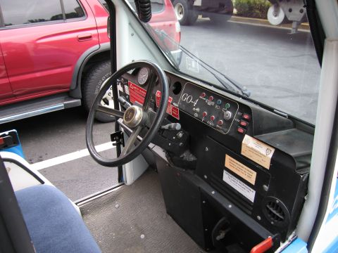 1991 Ford LTD Crown Victoria - Cramped interior of a police scooter with a steering wheel, dashboard switch panel and a GO-4 label.