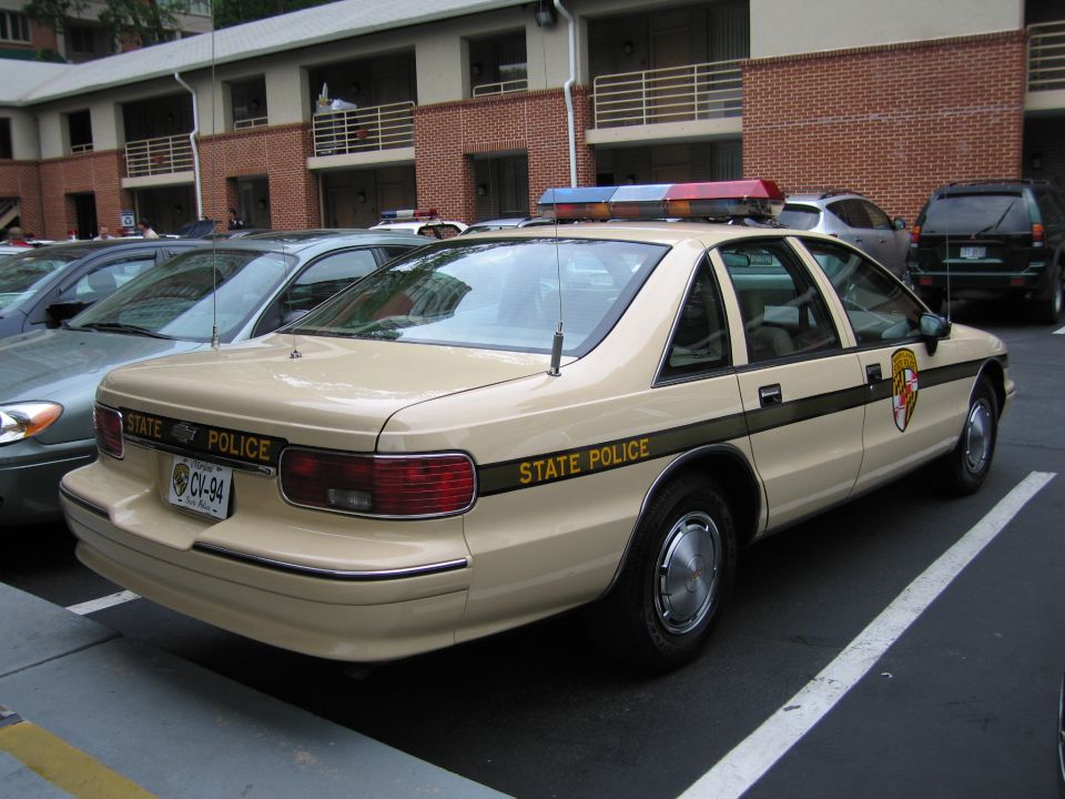 Tan Chevrolet Caprice marked Maryland State Police with plate CV-94, rear quarter view