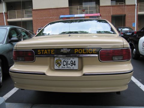 1991 Ford LTD Crown Victoria - Rear view of a tan Chevrolet State Police Caprice showing STATE POLICE lettering and Maryland plate CV-94.
