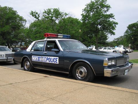 1991 Ford LTD Crown Victoria - dark blue and white NORTH HAVEN POLICE Chevrolet Caprice sedan with roof light bar parked at a curb.